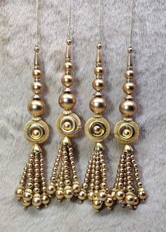 Indian Handmade Golden Beaded Lahenga Latkan Tassels for Saree Blouse HandBags Hangings Dupatta Bridal Wedding dress for Women pair of 2 pcs Size - 17.0 cm Length  Item Description You can use this Beautiful pair of tassle for several DIY projects.  *These beautiful Tassel Latkans are used as the accessory for saree blouse on the back, but u can use according to your need and your innovative ideas. * Package contains 2 Latkan / 1 Pair Other Than Saree Blouse, you can use these latkans in various ways Craft Projects Designing Home Decoration Festive celebrations. Evening and party Apparels. Home décor items Apparel & Fashion Scarves n Stoles Headband, hats Table cover, curtains, Pillow covers, Cushion cover Shoe designing Headband, hats Table cover, curtains Designing stylish blouses Ship F Cheap Gold Necklace With Latkans, Stylish Blouse, New Delhi, Bridal Wedding Dresses, Saree Blouse, Scarf Styles, Wedding Bridal, Pillow Covers, Craft Projects