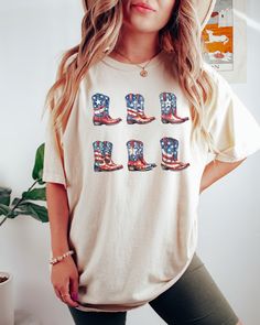 PLEASE NOTE, DUE TO THE BUSY HOLIDAY SEASON ANY ORDERS PLACED AFTER 12/09/24 ARE NOT GUARANTEED TO ARRIVE BY CHRISTMAS.Our Comfort Colors American Cowboy boots graphic tee would make the perfect t-shirt to wear this 4th of July, Memorial day or really any day you would like to showcase your western patriotism to the world. Comes in multiple colors! Check out more designs here: www.etsy.com/shop/jadeandroseshop ✨️SIZE AND FIT: Your shirt will be printed on a high-quality, soft and comfortable uni Casual White T-shirt For Country Concerts, Patriotic Crew Neck T-shirt For Fall, Fall Patriotic Crew Neck T-shirt, Americana Style Cotton Shirt With Graphic Print, Casual Letter Print Shirt For Labor Day, Casual 4th Of July Streetwear Shirt, Casual Shirt For 4th Of July Streetwear, Casual Streetwear Shirt For 4th Of July, Casual American Flag Print Shirt For Labor Day