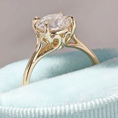 a gold ring with a white diamond in it