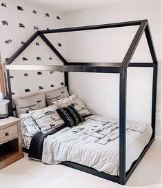 a bedroom with a canopy bed and white walls