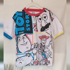 This Playful T-Shirt Features A Colorful Design Perfect For Any Young Toy Story Fan. The Shirt Is White With Contrasting Red, Blue And Yellow Trim For Added Style. The Front Graphic Showcases Beloved Characters Buzz Lightyear, Mr. Potato Head, Woody, And Rex In A Fun And Dynamic Layout. Made From Comfortable And Durable Materials. Size: 5/6 Color: White (Red, Blue, Yellow Accents) Material: 79% Polyester, 30% Cotton Care: Machine Wash Approx Measurements: Shoulder To Shoulder 14", Armpit To Armp Character Print Crew Neck T-shirt For Playtime, Crew Neck T-shirt With Character Print For Playtime, Multicolor Fun T-shirt With Character Print, Fun Multicolor Character Print T-shirt, Multicolor Character Print Fun T-shirt, Cotton Character Print Tops, Fun Character Print Tops For Playtime, Playtime Graphic Tee With Character Print, Graphic Tee With Character Print For Playtime