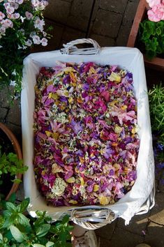 a white box filled with lots of colorful flowers