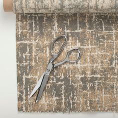 a pair of scissors sitting on top of a rug