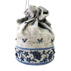 Look your best wearing this luxurious gray velvet potli bag bucket bag, exquisitely embroidered with glittery blue metallic flowers and embellished with genuine semi precious stones. It is certain to bring you compliments. Perfect Indian wedding bag. Expertly hand embroidered by third generation master zardozi artisans. . DETAILS: Measures approx 9" tall, base is 6" across. Useable interior space is 6" x 6 ". Rigid bottom and 2" base, so bag sits nicely. Wrist cord with tassel, 6 in. drop Additi Beaded Pouch Bag, Metallic Flowers, Costume Closet, Velvet Handbag, Adventure Bags, Beaded Pouch, Handbag Boutique, Potli Bag, Wrist Bag