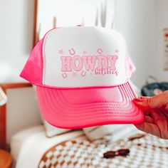 "Introducing the ultimate party accessory for bachelorette festivities - our Fun Pink Trucker Hat with the cheeky phrase \"Howdy Bitches\" embroidered on it! This vibrant and playful hat is designed to add a splash of fun and attitude to your celebration. Made with a comfortable fit, it features an adjustable snapback or strap closure, ensuring a customized fit for all the bachelorettes in your group. The striking pink color and bold lettering make a statement, letting everyone know it's time to Pink Mini Baseball Cap For Parties, Pink Novelty Bucket Hat, Pink Baseball Cap Mini Hats For Party, Bachelorette Party Adjustable Trucker Hat, Pink Novelty Mini Cap, Adjustable Trucker Hat For Bachelorette Party, Pink Novelty Mini Snapback Hat, Adjustable Trucker Cap For Bachelorette Party, Novelty Pink Hat With Letter Print