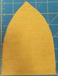 a yellow piece of cloth with a ruler next to it