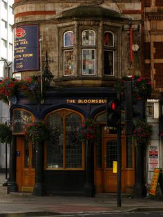 an old building with flowers on the outside