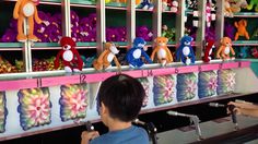 two children are playing with stuffed animals in a toy store's cash register area