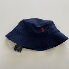 Polo Ralph Lauren Navy Blue Reversible Bucket Hat W/ Secret Pocket Size S/M 58cm New With Tags! Please Note That The Hat Is Reversible But Will Show The Polo Tag Upside Down. You Would Have To Remove Tags By Removing Its Stitching To Use It On The Other Side. There Is A Secret Pocket On The Top For Cash Or Card And There's A Loop You Can Use To Hang The Hat Or Attach Keys To It. Ralph Lauren Bucket Hat, Ralph Lauren Beanie, Ralph Lauren Cap, Ralph Lauren Hats, Polo Hat, White Baseball Cap, Orange Hats, Secret Pocket, Reversible Bucket Hat