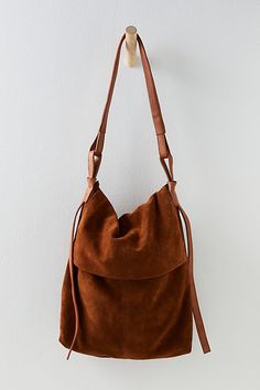 Unstructured for a laidback look, this slouchy messenger comes in a supple suede with a spacious interior for all your stuff. **Features:** Messenger style, suede fabrication, slouchy design, button flap closure, leather shoulder strap, interior zipper pocket **Why We | Roswell Slouchy Suede Messenger Bag by FP Collection at Free People in Brown Slouchy Purse, Cool Messenger Bags, Hand Bags For Women, Free People Bags, Diy Leather Bag, Boho Purses, Boho Bags, Brown Shoulder Bag, Beautiful Handbags