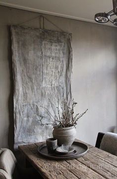 a wooden table sitting in front of a window with a vase on top of it