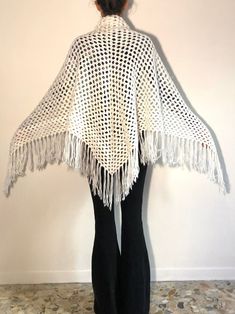 Lovely boho beauty fringe-tactic hand knit crochet triangular scarf from the 1970's. Hand crochet by a talented knitter this scarf is perfect for keeping you warm and bringing some light to the dark winter days. I love a white scarf in the dreary winter! Hand crochet in a wonderful open knit pattern. Wear this at the beach in winter, in front of a fire during chilly spring nights and for keeping warm at a festival. Great Stevie Nicks style. Yarn is soft and fluffy. No labels. I think that the ya Bohemian Open Knit Shawl, Bohemian Crochet Shawl In Acrylic Yarn, Bohemian Hand Knitted Shawl In Acrylic Yarn, Bohemian Knitted Shawl, Bohemian Knitted Shawl One Size, One Size Bohemian Knitted Shawl, Bohemian One-size Knitted Shawl, 1970 Crochet, Beach In Winter