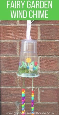 a garden wind chime hanging from a brick wall with text overlay reading how to make a fairy garden wind chime