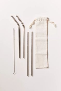 three stainless steel straws, two drinking straws and one reusable straw