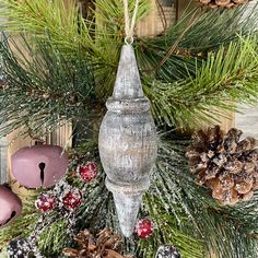 a christmas wreath with pine cones and candles