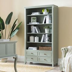 a living room with a couch, chair and bookcase