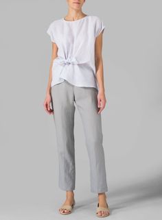 Chic Tied Tops For Summer, Chic Summer Tops With Tied Details, Chic Sleeveless Tied Top, Elegant Linen Tops With Tie Back, Elegant Linen Top With Tie Back, Chic Summer Tops With Tie Fastening, Chic Summer Top With Tie Fastening, Elegant Linen Tie Back Tops, Chic Tied Tops For Day Out