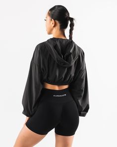 HIGHLIGHTS. Woven fabric Long sleeve Alphalete wolf logo FIT SUGGESTION. This item runs true to Alphalete's standard size... Jessica is 5’3”/160cm, wearing a size XS with a 30”/77.5cm bust. Sabrina is 6’0”/183cm, wearing a size XL. with 44.5"/113cm bust. MATERIALS AND WASHING DIRECTIONS. 100% Polyester. We recommend washing inside-out on a cold setting. Hang to dry DESCRIPTION With a silky smooth woven fabric, this jacket is perfect for wearing to and from the gym or during a cold outdoor workou Fitted Black Windbreaker For Sports, Black Fitted Windbreaker For Sports, Solid Fitted Long Sleeve Windbreaker, Fitted Solid Color Long Sleeve Windbreaker, Black Long Sleeve Moisture-wicking Windbreaker, Fitted Functional Black Windbreaker, Black Moisture-wicking Long Sleeve Windbreaker, Sporty Fitted Black Windbreaker, Black Long Sleeve Training Outerwear