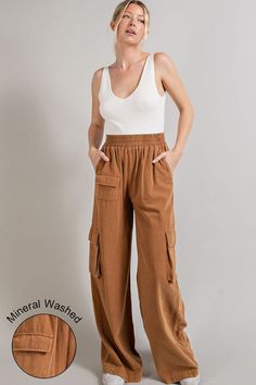 Fit for a day of city explorations, these wide leg mineral washed cargo pants are the epitome of style and functionality. Their distinctive mineral washed finish gives them a worn-in, vintage look that's both trendy and timeless. Equipped with multiple pockets, these pants offer ample storage space while maintaining a comfortable fit, making them a practical choice for outdoor adventures or casual outings. Product Details Material: Self: 100% Cotton. Fit: True to size. Inseam: 31.5” (size Small). Rise: 10.5”Fabric: Stretch cotton. Features: High waisted, wide leg, cargo pockets, elastic waistband, mineral wash. Model: 5’8” / Wearing a size Small. Care: Machine wash cold, gentle cycle. Tumble dry low. Shipping & Returns Free Shipping on U.S. orders +$100. We want you to be 100% satisfied wi Fall Acid Wash Bottoms With Pockets, Relaxed Fit Linen Cargo Bottoms, Casual Linen Parachute Pants With Cargo Pockets, Casual Linen Pants With Multiple Pockets, Casual Acid Wash Cargo Pants With Pockets, Fall Acid Wash Pants With Pockets, Acid Wash Pants With Pockets For Spring, Wide Leg Linen Parachute Pants With Cargo Pockets, Baggy Acid Wash Pants With Pockets