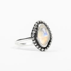 I handmade this beautiful natural Rainbow Moonstone gemstone ring from solid Sterling Silver. The gemstone has been surrounded by a beaded border. This ring looks great as a midi ring! Rainbow Moonstone is a variety of Labradorite, a member of the feldspar group, and features an iridescent sheen called "labradorescence." This means that the stone displays colors that change depending on the angle and source of the light striking the stone surface. In Rainbow Moonstone, this characteristic is due Color Changing Ring, Golden Jewelry, Stone Surface, Midi Ring, Midi Rings, Natural Rainbow, Rainbow Moonstone, Gemstone Ring, Aqua Blue