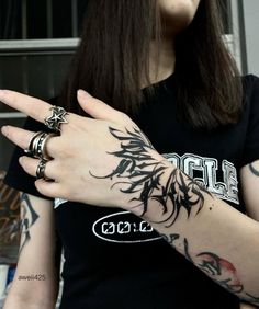 a woman with tattoos on her arm pointing at something