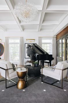 a living room filled with furniture and a grand piano