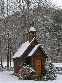 a small wooden church in the snow