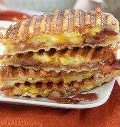 a stack of breakfast sandwiches on a plate