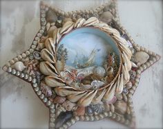 there is a painting on the wall with seashells and shells around it,