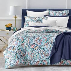 a blue and white comforter set with pillows