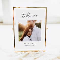 a photo frame with the words table one on it and a couple's face