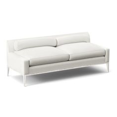 a white leather couch sitting on top of a white floor