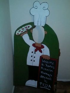 a painting of a chef holding a pizza on the back of a green chair that says welcome to your favorite pizzeria