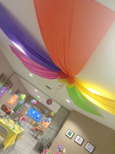 the ceiling is decorated with colorful streamers and balloons