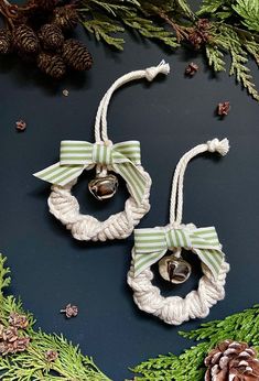 two christmas wreaths with bells hanging from them