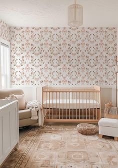 a baby's room with floral wallpaper and furniture