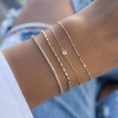 This super cute bezel bracelet is great for layering or wearing on its own! Delicate & dainty - this is perfect for a minimalist look. Made of 925 Sterling Silver 14K Gold or Rhodium plating Highest grade CZ for an authentic look! Bezel size: 4mm Includes 0.5" extension Lobster clasp closure Dainty Silver Bracelet Stack, Dainty Gold Bracelets, Bracelet Stack White Gold, Dainty Tennis Bracelet, How To Layer Bracelets, Gold And Silver Bracelet Stack, Silver And Gold Bracelet Stack, Cute Gold Bracelets, Dainty Bracelets Gold