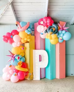 colorful balloons are arranged in the shape of letters and birds on top of each letter