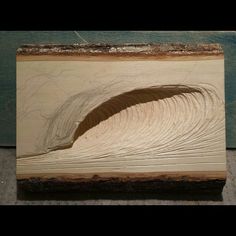 a piece of wood that has been carved to look like waves