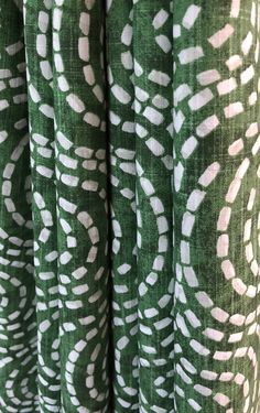 green and white patterned curtains hanging on the wall