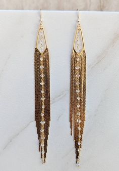 ONE OF A KIND Gold Fringe Earrings - Long Gold Tassel Earrings - Statement Earrings -Herkimer Diamond Chain- Triangle Shaped Gold Jewelry Stylish, fun, stunning earrings.  Perfect for Vegas, New Years celebrations or a night on the town.  You can wear these lightweight beauties with a vintage tee and jeans or a little black party dress.  3mm faceted Herkimer diamond quartz beaded gold filled wire and gold filled ear wires What is it: Herkimer diamonds are not actually diamonds, but double-terminated quartz crystals discovered in and around Herkimer County, New York. They are called "diamonds" because of both their high clarity and natural faceting. History: These crystals began forming about 500 million years ago in a shallow sea where sediments accumulated and lithified to form bedrock. W Gold Fringe Earrings In Brass, Elegant Long Drop Fringe Earrings, Gold Fringe Drop Earrings, Gold Dangle Tassel Earrings For Celebration, Elegant Gold Teardrop Tassel Earrings, Dangle Tassel Earrings For Celebration, Elegant Metal Fringe Jewelry, Gold Fringe Chandelier Earrings As Gift, Elegant Brass Earrings With Dangling Beads