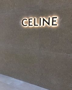 a sign that reads celline on the side of a building with lights above it