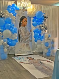 a display with blue and white balloons in the shape of a woman's head