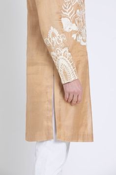 Gold straight kurta featuring ivory aari embroidery in floral and geometric pattern. Paired with contrasting plain pant. - Aza Fashions Fitted Raw Silk Sherwani With Embroidered Border, Festive Wedding Sets With Tonal Embroidery, Festive Beige Kurta With Embroidered Border, Eid Straight Kurta With Tonal Embroidery, Raw Silk Sherwani With Embroidered Border And Straight Kurta, Raw Silk Sherwani With Embroidered Border, Sherwani With Embroidered Border In Raw Silk, Embroidered Border Sherwani In Raw Silk, Elegant Transitional Sherwani With Embroidered Border