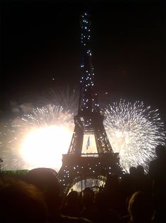 the eiffel tower is lit up with fireworks