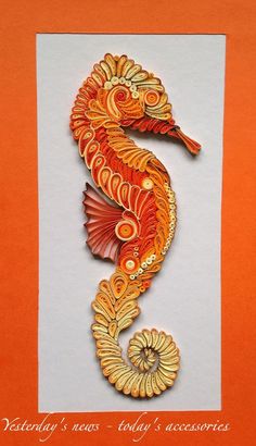 an orange and yellow seahorse on white paper