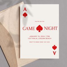 a card game night party is set on top of some envelopes with red playing cards