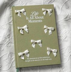 an open book with white bows on it