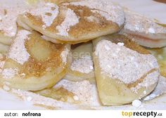 a white plate topped with banana slices covered in powdered sugar