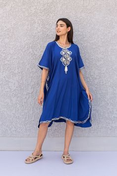 "This beautiful tunic dress has a unique presence to it. It's elegant and most importantly comfortable wear, light and soft and can be used on many occasions - home gatherings, dinners, or just in your home to feel comfortable. Fabric : 80% Egyptian Cotton and 20% Polyester Measurements : Free size. Fits up to 5XL. Also there is a belt that can be used to tighten the dress around the hips. Bust size : 72 inches Length : 39 inches **Note : The Tunic in the video is a different color of the exact Festive Tunic Kaftan With Embroidered Neckline, Blue Summer Kurta With Embroidered Neckline, Summer Blue Kurta With Embroidered Neckline, Traditional Flowy Tunic Dress, Beach Tunic For Eid, Traditional Tunic With Embroidered Neckline For Eid, Festive Bohemian Kaftan With Embroidered Neckline, Eid Vacation Tunic Kurta, Traditional Embroidered Tunic For Eid